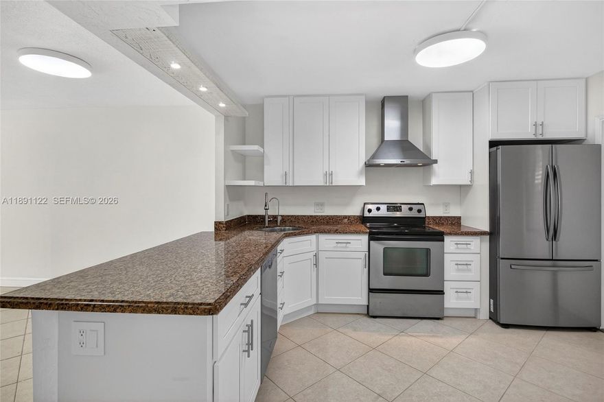 Beautifully updated 2 bed, 2 bath first-floor condo. New white kitchen cabinets. All impact windows and doors. Stunning lake views, featuring tile flooring throughout, quartz countertops, stainless steel appliances. Living room and dining room feature modern built-ins for extra storage. This bright & airy unit is filled with natural light. Both bedrooms are en-suites, with the primary offering a spacious walk-in closet. Enjoy relaxing lake views from your private, enclosed impact-glass patio. The condo is extremely well maintained, and is located in a building with reserves that has passed the 40-50 year inspection. Monthly fee covers water, cable, internet, reserves and more.  All ages welcome, minutes from shopping, restaurants, casino, and Pompano Bch. Price improvement. Priced to sell.