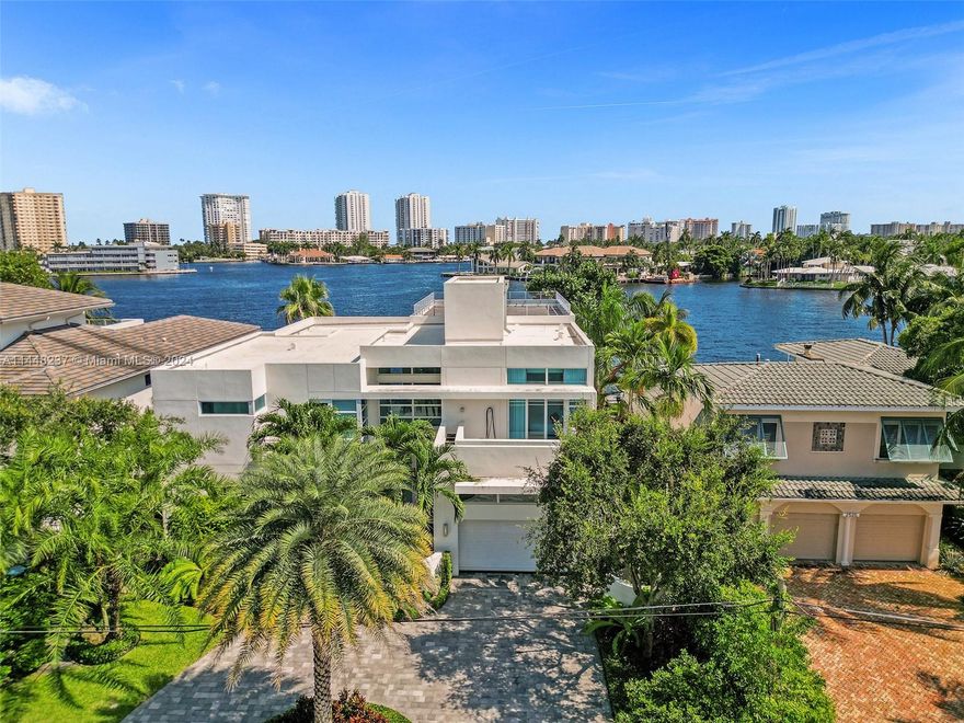 Exquisitely modern, every luxurious touch imaginable... sweeping Intracoastal + Lake Santa Barbara vistas views! It’s all here with a brand-new living vibe. Back yard entertainment utopia w/ soaring column-draped loggia, saltwater pool, spa + outdoor kitchen. Private pier, concrete dockage (30x45 feet) + resealed seawall (’23). Inside, showcase glass elevator, towering ceilings, lux porcelain tile, top-line fixtures/lighting + tons of windows w/ panoramic views. 5 total bedrooms + 5.5 baths – all bedrooms have upgraded ensuites! Primary w/ expansive private terrace + water vistas! Plus, a stunning upper level 1,000sf terrace to soak in the South Florida lifestyle in its total pinnacle. Minutes to Hillsboro Inlet, executive airports, premier golf destinations + more. Book your showing now!