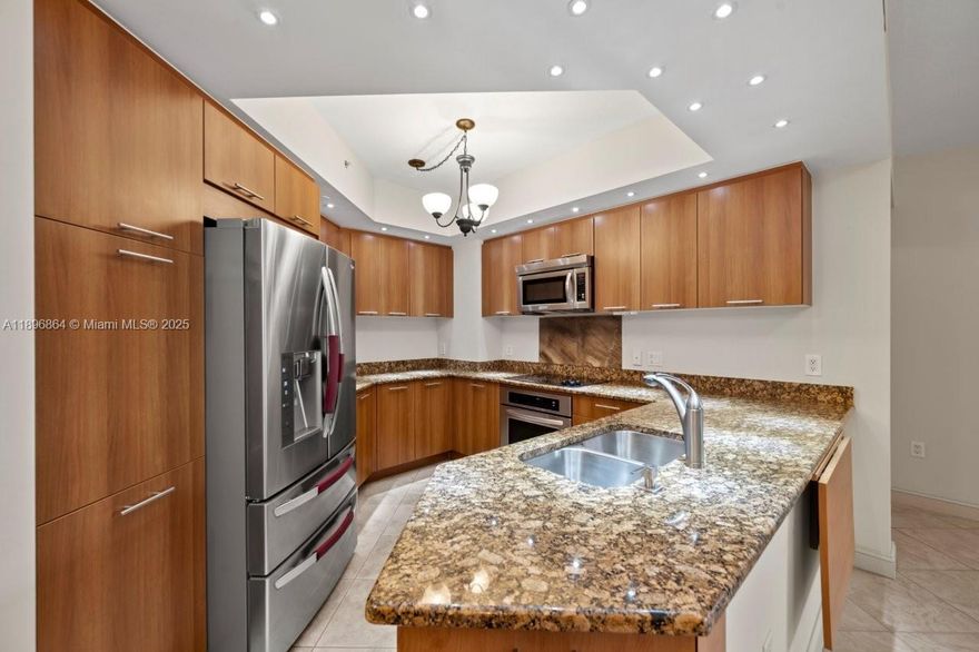 Completely upgraded condo featuring tile floors throughout, granite counters, and stainless steel appliances. Built-in closets and high-impact doors and windows add both style and security. Enjoy serene pool views and resort-style amenities including a tropical heated pool, hot tub, sauna, clubroom, and fitness center. Building offers 24-hour concierge, on-site management, and advanced security cameras. Includes water, internet, cable TV, and two assigned garage parking spaces. Master bath with marble shower and soaking tub. Washer/dryer and Smart Key FOB entry complete this luxurious residence.