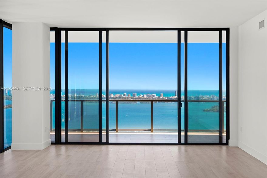 Located on the 55th floor of Elysee, this flow-through residence enjoys panoramic views from sunrise to sunset. Floor-to-ceiling glass and an east-to-west layout create a light-filled interior with open sightlines throughout. The living room, kitchen, and east-facing terrace overlook Biscayne Bay and the Miami Beach skyline, while the west-facing terrace offers expansive sunset and city views.

The residence is accessed via a private elevator and foyer and features 4 bedrooms, 4.5 bathrooms, and a spacious den. The primary suite includes floor-to-ceiling windows, a spa-style bathroom with a large soaking tub, custom marble shower, and an oversized walk-in closet.

The kitchen is thoughtfully designed for both daily use and entertaining, featuring Italkraft cabinetry, Wolf and Sub-Zero appliances, and a gas cooktop. Well-proportioned living spaces and refined finishes provide comfort, functionality, and flexibility.

Building amenities include sunrise and sunset pools, a state-of-the-art fitness center, a private owner’s lounge on the 30th floor, a children’s playroom, valet service, and 24-hour concierge. Offering privacy, generous living space, and full-service amenities, this residence is ideally positioned in one of Edgewater’s premier waterfront buildings.