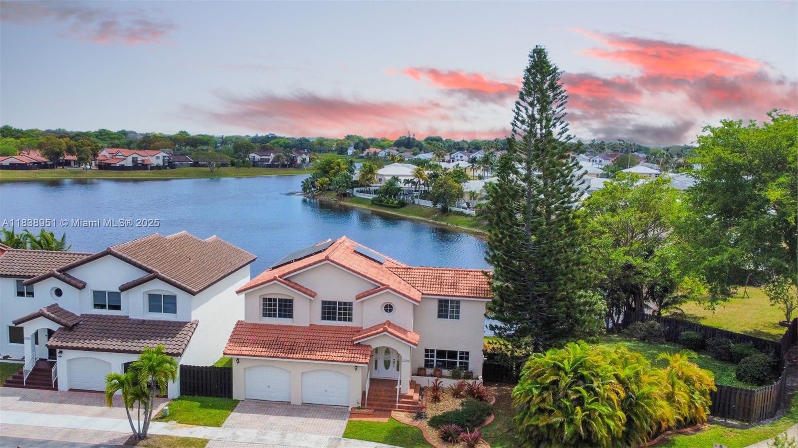 DISCOVER THIS MASSIVE TWO-STORY LAKE HOUSE WITH THE BEST LAKE VIEW IN ALL THE DEVELOPMENT. Sitting on an spacious 8,624sq ft lot, it features the second-largest lot on the lake. With unobstructed views, it’s perfectly positioned to capture the stunning full moon reflection on the water from the master suite balcony while feeling the lake breeze. Inside, enjoy a spacious floor plan with 4 bedrooms, a screened terrace, a master suite balcony, impact windows/doors, a renovated kitchen, two-car garage, and Paid-off solar panels that will power the house.
FEATURES:
Perimeter fence (2022)
Paid-off solar panels with charging power cell(2021)
New washer & dryer
5-ton AC unit (2009)
Remodeled kitchen
Screened patio
Master suite balcony
Full alarm system
This Is Waterfront Living
