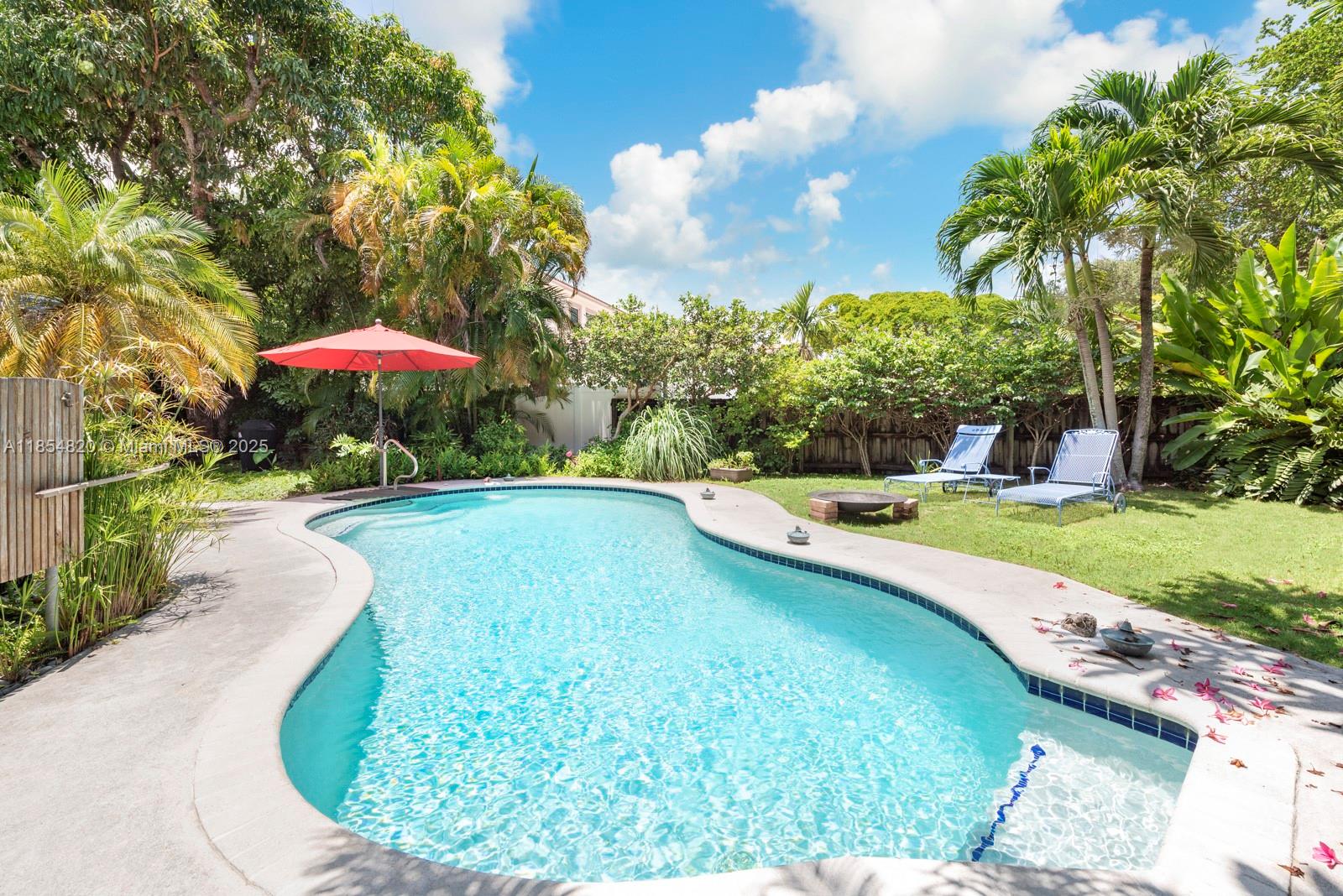 Charming Biscayne Park oasis with artisan craftsmanship and lush outdoor living. Though compact in size, the
smart layout lives large and includes plumbing for an additional bath. Features impact windows, custom kitchen
with solid wood cabinets, slate countertops, and high-end finishes crafted by the owner, a master carpenter.
French doors open to a covered porch, pool, outdoor shower, and private backyard. Detached, air-conditioned two-story workshop with garage doors and a loft could easily be converted to an accessory dwelling. City gas, indoor
laundry, and ample parking complete this rare find.
