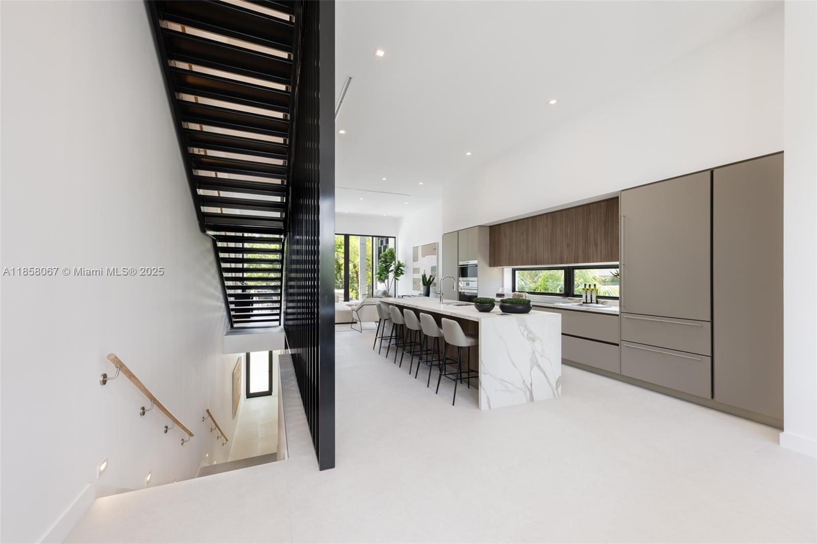 Award-winning contemporary residence in The Roads Townhomes featuring a distinctive formed-concrete façade. A dramatic open stairwell, volume ceilings and skylight define the airy interior. The sprawling second-floor living space with 12’ ceiling flows to a giant, glass-walled terrace. The chef’s kitchen offers Italian cabinetry, Wolf-Sub Zero appliances, porcelain slab surfaces and 10’-wide island for prep and counter dining. Spa-style master bath includes a freestanding tub, dual vanities and glass-walled shower. Additional highlights: multiple balconies, sound-insulated, private entry courtyard, Mondrian-inspired privacy screens, full-size 2-car garage and concrete construction with impact glass.