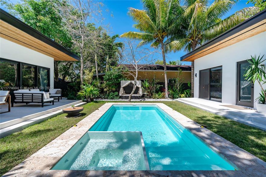 WELCOME TO CASA BUENA VISTA TROPICAL - A CRAFTMAN'S MASTERPIECE completed in ‘25! FULLY FURNISHED GEM w/ GUEST HOUSE & POOL in Buena Vista just blks from DESIGN DISTRICT & mins from WYNWOOD, SOBE, AIRPORT, & DOWNTOWN. The 3/2.5 MAIN HOME blends STYLE & FUNCTION - 12’ ceilings, ample storage, IMPACT windows/doors, FRAMELESS WOOD DOORS, remote blinds, HARD OAK FLOORS, & MIELE KITCHEN with 11’ ISLAND, BUILT IN COFFEE MAKER, & minibar. The 1/1 ADU boasts 12’ ceilngs, FULL BOSCH KITCHEN, impact sliders, & EXCELLENT RENTAL POTENTIAL. The LUSH 7,200sf GATED LOT features TROPICAL FRUIT TREES, HEATED 12’x20’ SALTWATER POOL w/ SPA, & custom OUTDOOR KITCHEN. VIVINT security system, water well, & DRIVEWAY FOR 4 CARS, small boat/RV make this A RARE FIND FOR END USERS & INVESTORS ALIKE!