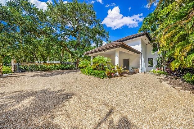 Modern House on a large lot with pool and beautiful landscaping in the heart of Coconut Grove. The house offers a great floor plan with ample and bright spaces. The house features 5 Bedrooms + Den and 4 in suite Bathrooms plus a powder cabana bathroom. The house has an exceptional backyard featuring a pool, seating area, bar with BBQ and TV. Great for gatherings and entertainment. The front house can accommodate a playground plus 4 cars. The house has easy access to everywhere and walking distances to A+ Schools in Coconut Grove.