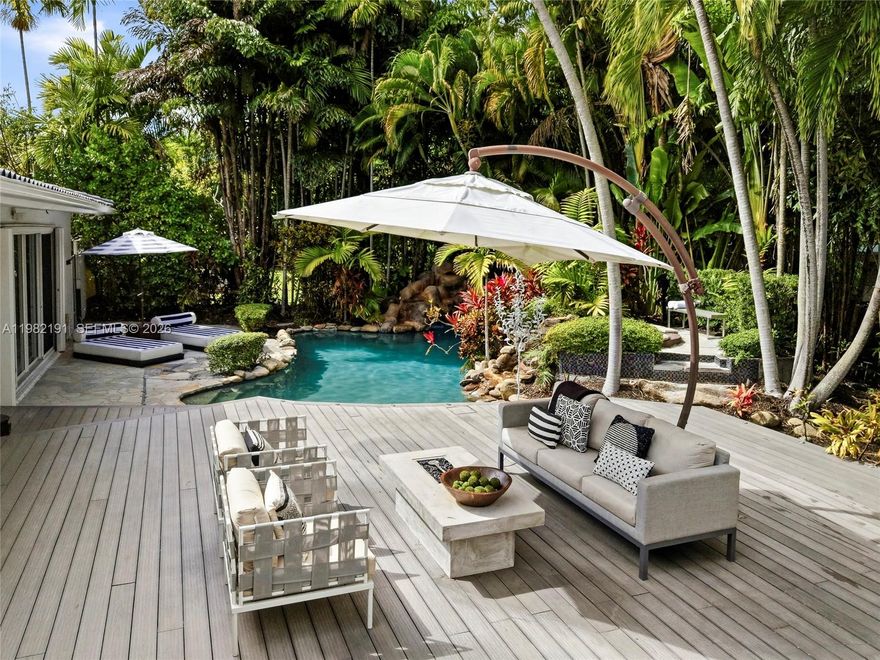 Enjoy the tranquility of a private retreat in a quiet bayfront enclave nestled between Miami Shores and Davis Harbor. With 1,912 SF of thoughtfully designed living space, this contemporary residence offers two spacious bedrooms, with the flexibility to convert to a 3 BD/2 BA. Blending indoor and outdoor living on an 11,300 SF lot, the lushly landscaped backyard oasis features a heated tropical pool with dual waterfalls. An expansive entertainment deck includes an outdoor chef’s kitchen and a pergola-shaded dining area, ideal for al fresco gatherings. Smart home technology and a Tesla EV charger add modern convenience. Enjoy easy access to shopping and dining in Miami’s Upper East Side and Little River neighborhoods, with Miami Beach, Bal Harbour, and the Design District just a short drive away.