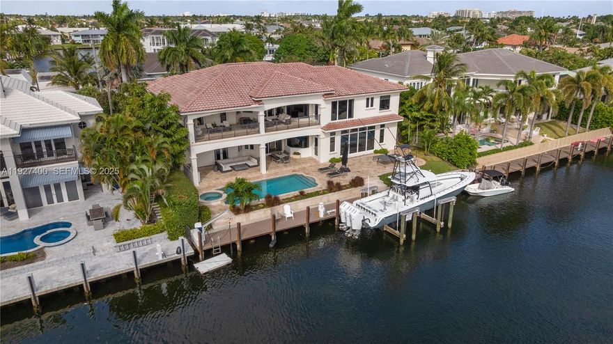 Welcome to the ultimate boater’s estate in Lighthouse Point. Situated on a prestigious cul-de-sac, this Mediterranean residence sits on a massive turning basin, offering expansive water views and effortless maneuverability for large vessels. The property features 100 feet of water frontage with no setbacks and a brand new 32,000 lb Hurricane boat lift.

Enter through double doors to soaring ceilings, travertine flooring, and water views from the moment you step inside. The floor plan is designed for multi-generational luxury, featuring a residential elevator and dual laundry centers (upstairs and down). The kitchen was recently refreshed with new quartz countertops, opening to a spacious family room. The first floor hosts two guest suites, including a VIP suite with a fully remodeled 2024 ensuite bath and walk-out pool access.

Upstairs, discover a dedicated executive office, a remodeled morning bar/coffee lounge, and a gym (or additional bedroom) with a private balcony. The exterior is an entertainer's paradise featuring a sprawling covered loggia, summer kitchen, heated pool, and spa. Recent Upgrades: Full-home Generac generator, impact windows/doors, 1 new A/C unit (2025), new landscaping, 3-Car Garage. Unbeatable value on a street with neighboring $10M+ estates.
