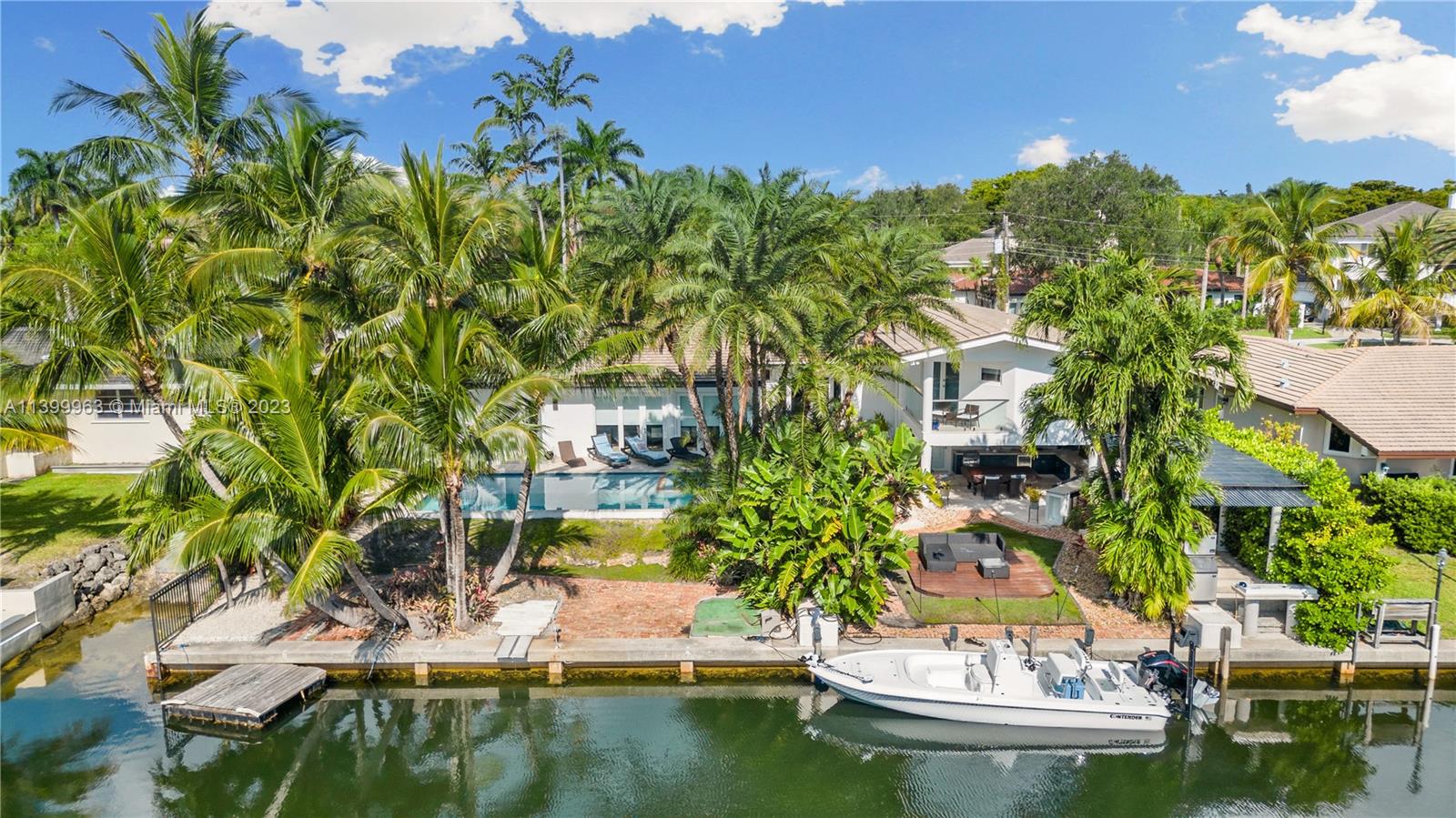 Welcome to paradise! This stunning waterfront home w/Bay access perfectly blends elegance, comfort, & coastal living in the prestigious Gables by The Sea community. The well-designed floor plan features 5 bedrooms, providing ample space for family & guests. An updated kitchen w/modern appliances makes this a culinary enthusiast's dream. The living areas are thoughtfully designed for relaxation & entertainment. One of the highlights of this home is its seamless integration of indoor & outdoor living. Discover a private oasis featuring a sparkling heated pool, outdoor kitchen, & a cabana bath. 100' waterfront w/ convenient one-bridge ocean access. Fully permitted brand new 17,000 lb. Neptune boatlift, Impact windows & 2020 roof. Prime location on double cul de sac w/ 24/7 guard gate.