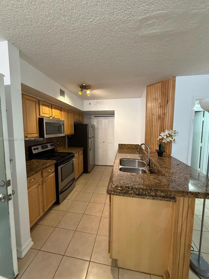 Excellent value in this 2-bedroom, 2-bath first-floor condo located in the gated community of Pinehurst Club in Hollywood! This well-maintained unit features a desirable split-bedroom floor plan and tile flooring throughout. The spacious primary suite offers a large walk-in closet, and the renovated primary bathroom includes dual sinks and modern finishes. The second bedroom is generously sized with ample closet space.
The updated kitchen boasts granite countertops, light wood cabinetry, and stainless steel appliances, including a glass-top range, microwave, and refrigerator. Enjoy a screened patio with a full-size washer and dryer for added convenience.
Brand new air conditioning system and all appliances are included, making this home completely move-in ready.
Prime location, just steps from the community pool and gym, and minutes from downtown Hollywood, shopping, dining, major expressways, the beach, and Fort Lauderdale-Hollywood International Airport.