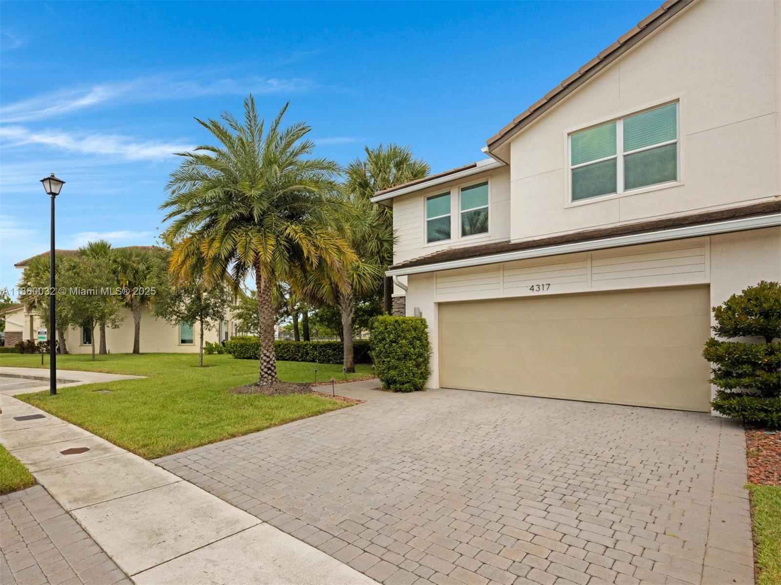Waterfront Townhouse - Deluxe end unit extra windows desirable gated Veleiros community. Energy-efficient smart home built in 2020 impact windows and doors. Upgraded landscaping with Sylvester Palm private covered entry - upgraded flooring, two-car garage + 2 sports outside and guest parking very near Island kitchen with quartz countertops, deluxe appliances and cabinets upgraded faucet and reverse osmosis system. Whole house water filtration. Spacious Primary Suite with an en-suite bath offering a waterfront view. On opposite side - two guest bedrooms a full bath and laundry room. Clubhouse offers heated swimming pool, modern gym, playground, social area, screened picnic pavilion and lounging deck. Located between I-95 and the Turnpike minutes from beach, dining, casino, grocery stores.