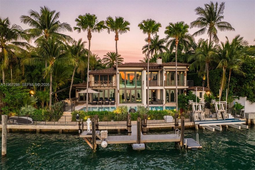 Casa Mare is a masterfully reconstructed waterfront estate on the Venetian Islands, offering the pinnacle of direct open-bay & Downtown skyline views with spectacular sunsets. Arrive to tropical gardens, koi ponds, water features, and a meditation/yoga deck. 20-ft ceilings welcome you in the living room, with detailed finishes throughout - French oak and travertine floors, brass inlay doors, and pearled Venetian plaster. Warm and serene, it blends Art Deco Mediterranean design with subtle Asian influences. Enjoy a heated pool, summer kitchen, and approx. 110’ of waterfront w/dockage for a 90’ yacht. Includes a generator, state-of-the-art A/V & security cameras, UV filtration system, onyx bar, gated entry, 2-car A/C garage with EV charger, primary balcony jacuzzi, & guest house.