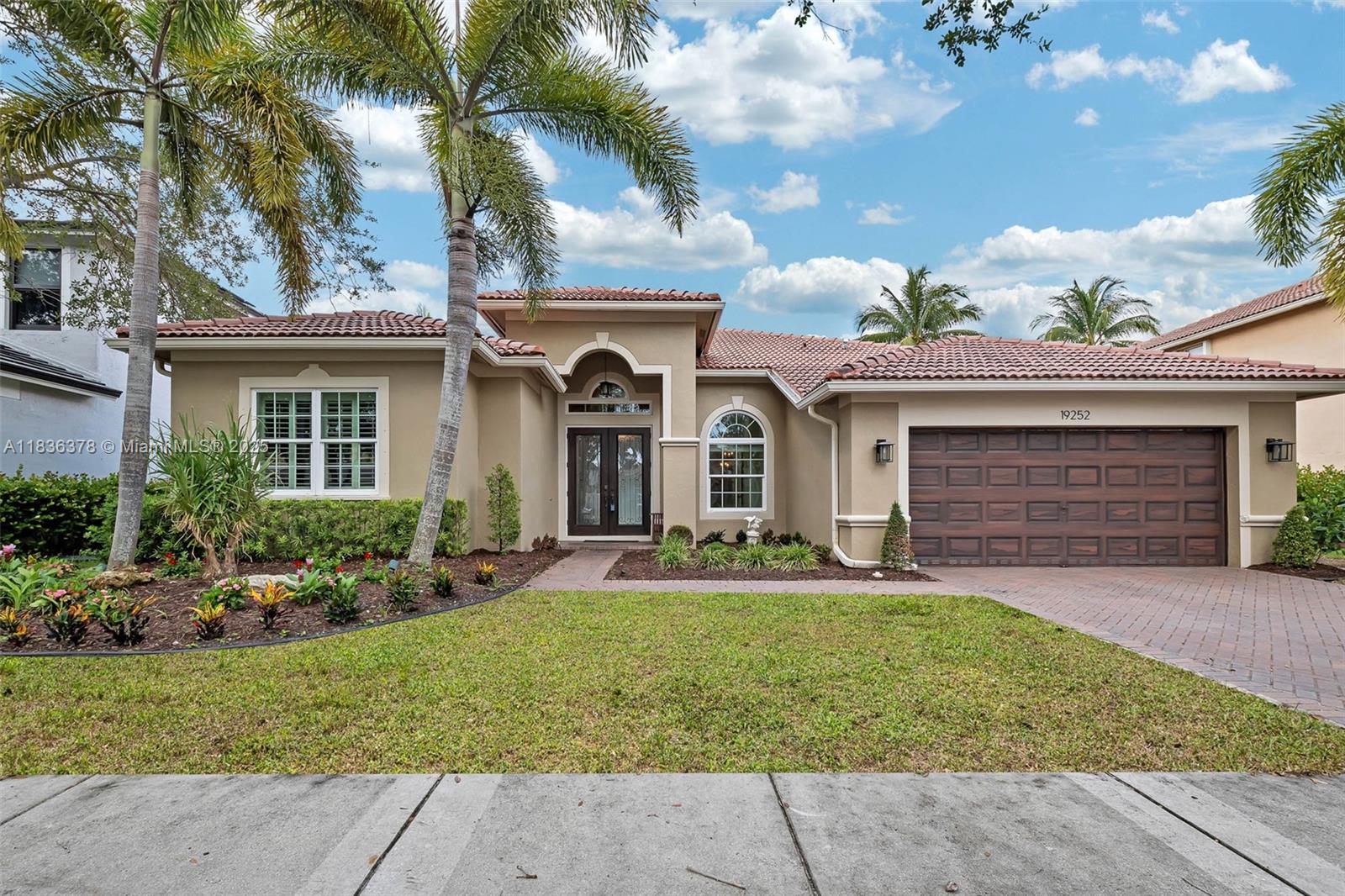 Step into this beautifully transformed lakefront and pool home in the sought-after Isles of Weston, where every detail speaks to quality and style. Awaken each day to shimmering LAKE views from your elevated JACUZZI, perfectly poised above the sparkling heated, salt-water POOL. A fully pavered patio and pergola invite unforgettable moments outdoors, while IMPACT windows and doors blend security with sleek design. Inside, the chef’s kitchen and spa-like bathrooms have been masterfully RENOVATED with the finest materials and craftsmanship. This elegant one-story home offers a thoughtful three-way split layout with 4 bedrooms and 3 baths—all enhanced by custom plantation shutters that add timeless charm.
