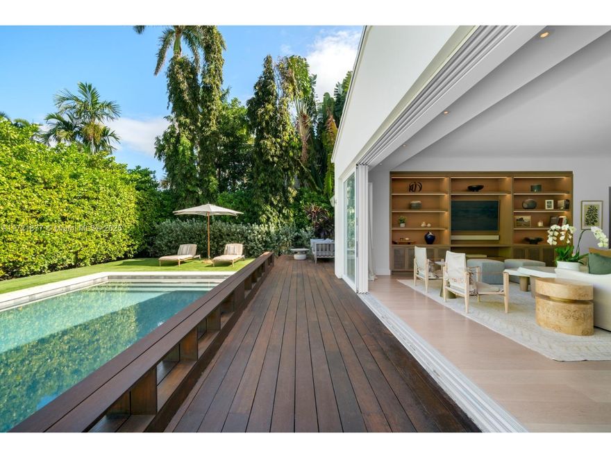 A tropical oasis of unparalleled beauty, this meticulously renovated Venetian Islands residence has been transformed into a sanctuary of modern luxury. Nestled on an expansive 11,250 SF lot, this 5-bedroom, 4-bathroom masterpiece offers 3,215 SF of bright & airy living space. Every detail has been curated to perfection, featuring top-of-the-line custom millwork & oak wood flooring throughout. The open kitchen showcases marble countertops and backsplash, along with Wolf/SubZero appliances. The primary suite is a tranquil haven complete w/ custom closets and a spa-like bath wrapped in natural stone. Exteriors featuring a heated saltwater pool, IPE decking and lush landscaping. Fully upgraded with cutting-edge AC systems, Sonos sound and generator, this gated home combines style and privacy.