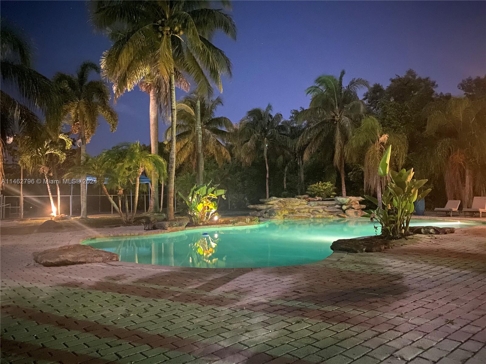 Welcoming this STUNNING Redland compound back to the market after a partial renovation with more improvements AND new pictures to come! This sprawling 2.25 acre estate home is perfect for large families or let your dreams come true with different business opportunities. Spacious 6 bedrooms, 4 full bathrooms, Chef's kitchen, living room & working fireplace. Oversized main suite offers jacuzzi, & more! Wet bar, media, game room. Full size tennis court with seating & new lighting, resort-style beach entry heated pool with waterfall, large barbecue outdoor kitchen, generator with (2) 1000 gallon underground propane tanks powers the entire home for weeks! Barn features 4 stables with 2 tiled rooms, or convert into guest home. Amazing full size treehouse large enough to sleep with zip line!