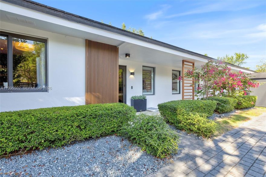 Ideally located in the heart of South Miami, just minutes from the University of Miami and Coral Gables, this fabulous, turnkey residence offers a bright, open layout and seamless indoor-outdoor living. Designed with a refined, contemporary aesthetic, the home features an Italkraft kitchen with Sub-Zero and Wolf appliances. Light oak hardwood floors paired with Italian porcelain add warmth and sophistication throughout. The recently built primary suite offers a spa-inspired bath with Graff fixtures and a smart toilet. Outdoor spaces are equally impressive, featuring a heated saltwater pool finished in Dominican coral rock, along with a summer kitchen complete with a Coyote gas grill and Perlick ice maker. The converted garage has been transformed into a striking lounge/media room with custom millwork, ideal for entertaining or showcasing a prized collection. Additional highlights include Phillip Jeffries and Élitis wallpaper, Italian closets, motorized shades and wood shutters, impact windows and doors, 2017 roof, motorized front gates, in-ceiling speakers throughout, low voltage landscape lighting, and a double carport with full electric enclosure. Enjoy close proximity to top schools as well as Sunset Place, Shops at Merrick Park, and a variety of dining and entertainment options, with easy access to major roadways.