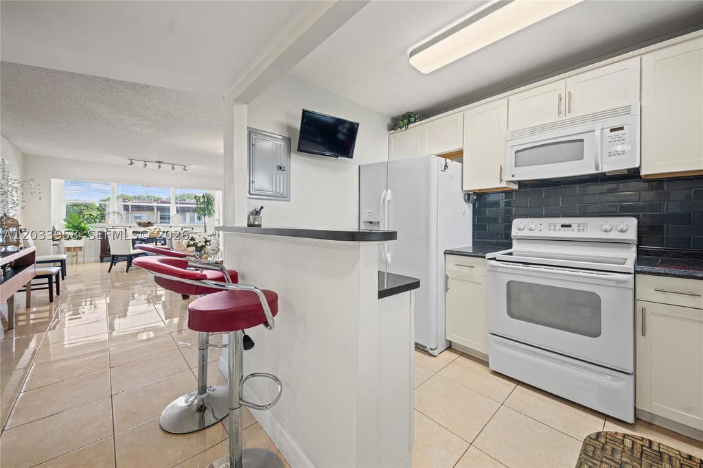 Photo of 8951 Sunrise Lakes Blvd #301, Sunrise, FL 33322 (MLS # A12033958)