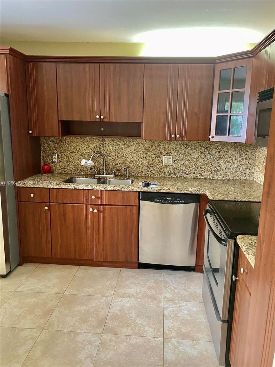 2-bedroom, 2-bath unit in Garden at Bonaventure, Weston, with an excellent location close to shopping and A+ schools. Features washer and dryer in unit, stainless steel appliances, wood cabinets, granite countertops, tile and wood flooring, and extra storage. Enjoy access to Town Center amenities, including a gym, basketball courts, bowling, and a theater.