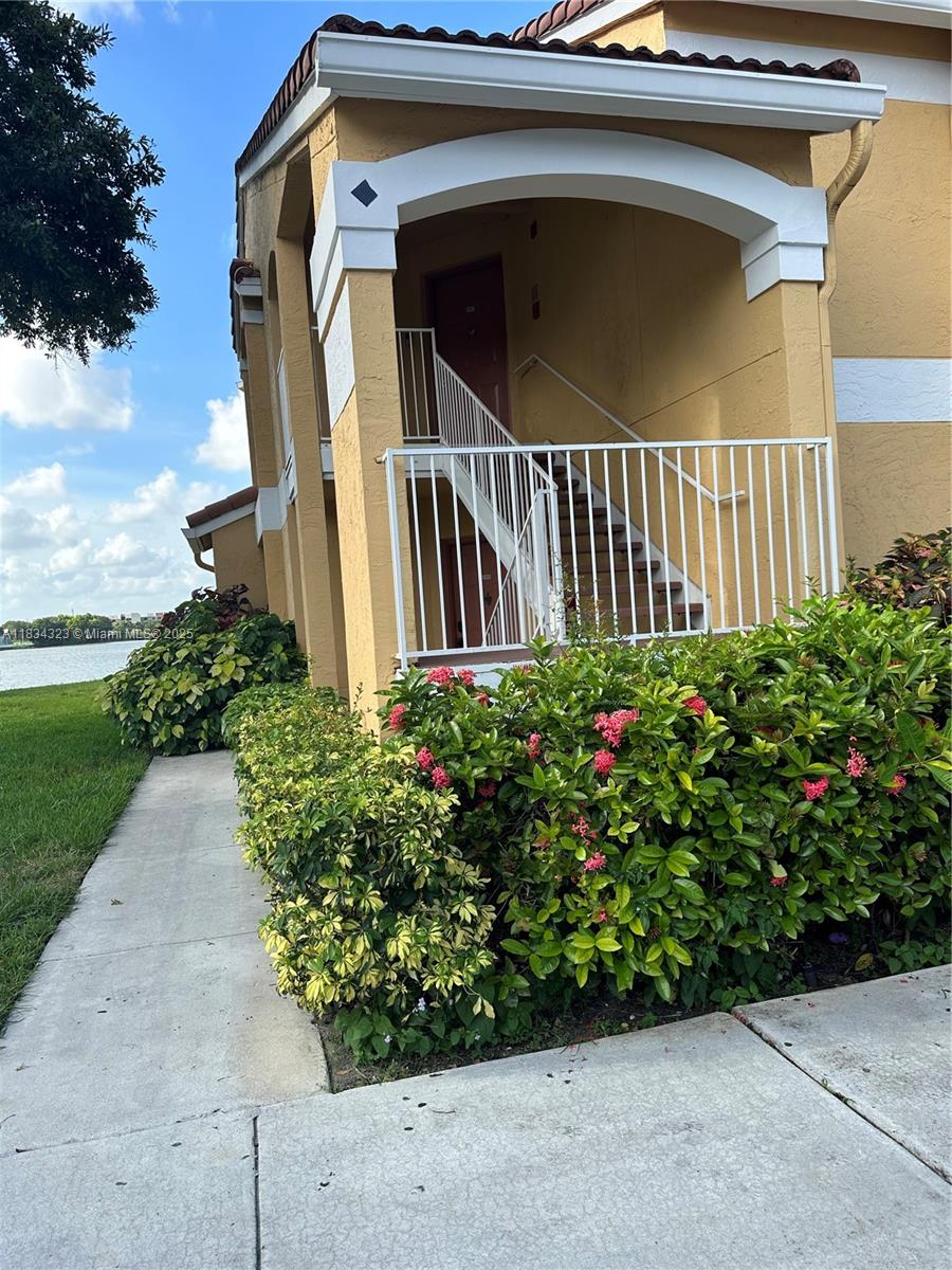 Spacious and Rarely Available Corner Unit at Sailboat Point! This is one of the largest units in the community, boasting 1,241 sq ft of living space. Located on the second floor, this corner unit offers a private entrance and features beautiful bay windows in the living room, flooding the space with natural light. Enjoy breathtaking lake views from both the master bedroom and living room. Gated community with resort-style amenities, including a clubhouse, swimming pool, hot tub/spa, fitness center, business center, and tennis courts. There is on-site management and roving security for added peace of mind. Additional highlights include: Hurricane impact windows, In-unit full-size washer and dryer, Ample parking, with your designated spot right in front of the unit. This unit is a must-see!