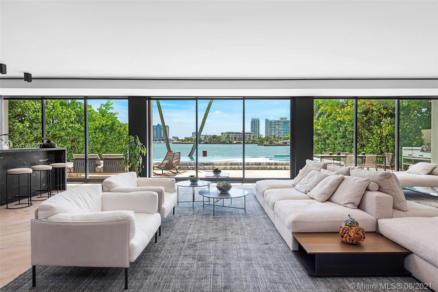 An extraordinary modern waterfront estate offers a completely custom living experience where every space was created to achieve a resort-like lifestyle bursting with amenities. Exquisite features include Boffi baths, Porsche lighting, Gaggenau appliances, custom Italian cabinetry, spacious kitchen, dining, bar & entertainment areas, commissary kitchen & laundry & staff quarters accessible through a service entrance. The principal suite & spa bathroom transport you to a tranquil resort w/ a rooftop deck to enjoy panoramic views of South Beach. Vertical gardens & organic stone claddings soften the exterior & provide a tropical modern feel. The outdoor experience is completed by a Statuario Marble clad acrylic infinity edge pool, jacuzzi & Ipe dock.