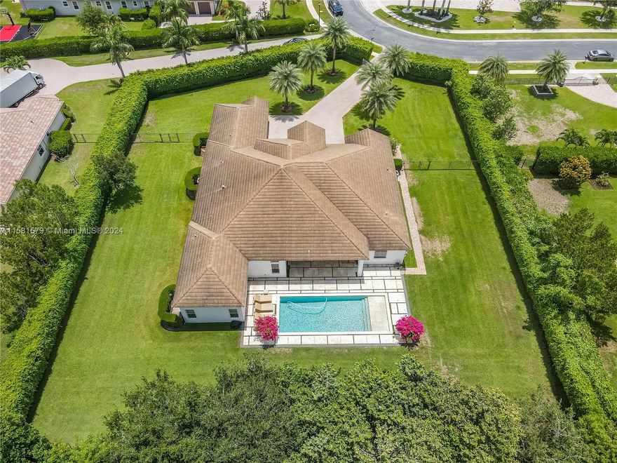 Indulge in the epitome of luxury living with this 5-bed, 5.5-bath sanctuary in the exclusive enclave of Woodbridge Ranches. Crafted in 2016 on a sprawling acre, this residence exudes over 5,000 sqft of sheer luxury. Immerse yourself in extravagance with water-resistant wood floors and impact windows throughout. The heart of the home beckons with a modern kitchen boasting quartz counters – a culinary dream come true. Retreat to the lavish primary suite with vast closets, while each bedroom offers its en-suite haven. Step outside to your private oasis, where a saltwater pool, synthetic grass, and paver deck await your relaxation. Nestled in Davie, mere moments from the Cleveland Clinic, premier schools. And next to a state-of-the-art dream equestrian facility. Premier boarding is available.