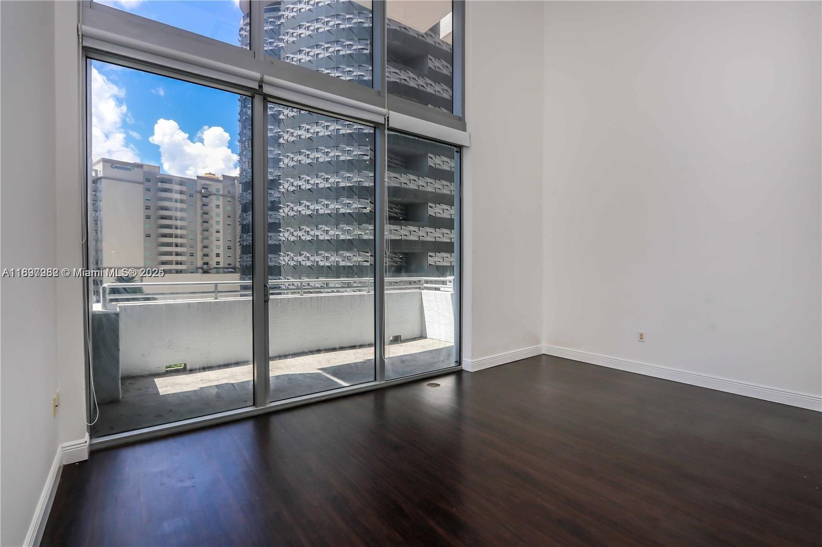 If you want the feel of a townhome(duplex) in the heart of the city, take advantage of this opportunity to own a rare large 2-story loft townhome w/ 20 feet soaring ceilings and windows on a lower floor with large balcony and city view, best building and location on Brickell Ave. Home features 1 large bedroom upstairs plus a small den area for office and 2 full bathrooms.A full bath with bathtub/shower combo upstairs and a full bath with shower on the main level for your overnight guests.Features partially open kitchen,still separate from living room area to allow for wall space, furnishings and privacy.Unit features wood laminate flooring throughout with modern kitchen and baths.Building amenities include 2 pools,gym,sauna,recreation areas,business center, Valet Parking,doorman security.