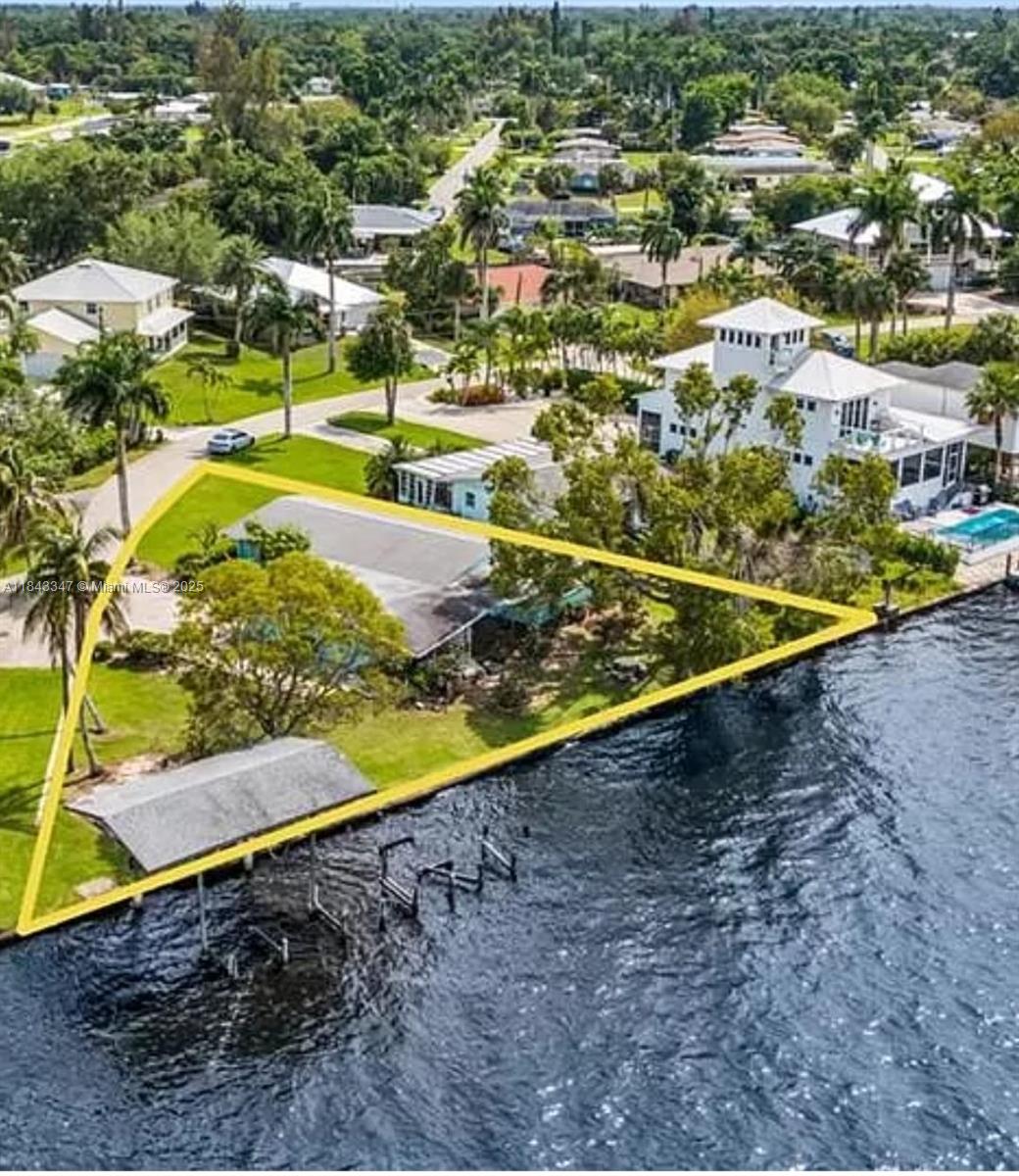Come build your dream home just minutes from downtown Fort Myers, yet far enough to enjoy peaceful sunsets on your own riverfront oasis. This property is a boater’s dream or a perfect opportunity for an investment or Airbnb. Nearby homes boast 90% occupancy rates and earn up to $450 per night. Featuring an impressive 158 feet of direct river frontage, more than any other property in the area, this cleared lot comes with no assessments. Located on a quiet cul-de-sac with zero through traffic, it offers unmatched privacy. The site is approved for a 3,000 sq ft home on concrete pillars, with room for a pool as shown in the renderings. Just a short boat ride to the Gulf of Mexico! Call listing agent today!!