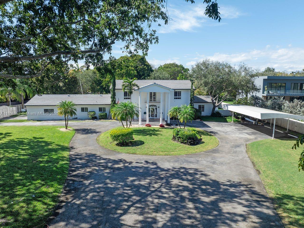 Nestled within the Village of Pinecrest on a rare gated corner parcel exceeding one acre, this exquisite Colonial Revival estate marries timeless architectural elegance with sophisticated modern living. With seven generous bedrooms and 6½ baths, a chef’s gourmet kitchen complete with butler’s pantry, top-tier upgrade details like a new roof and impact-rated windows, and soaring ceilings throughout, the home is bright, airy and perfect for both refined entertaining and relaxed family life. Set amidst lush, manicured grounds in steps from premier schools, parks, dining and shopping, it offers exclusive value in Pinecrest’s luxury market. This unique offering blends privacy, land, and turnkey elegance in one compelling package. Schedule your private tour today!