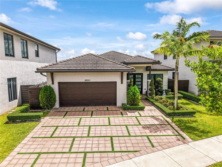 Newer 2021 Construction. Single-story residence situated within the private & guard-gated community of Satori in Miami Lakes. Custom finishes with a contemporary design , offering effortless indoor-outdoor living. The property showcases impact windows and doors, lush landscaping with custom lighting, refreshing pool areas with a waterfall spa, a covered terrace, plus an outdoor, perfectly complemented by elegant marble decking, and artificial turf for low-maintenance enjoyment. Inside the home features hight-volume ceilings and abundant natural light, creating a bright-open atmosphere throughout. The kitchen is enhanced with custom breakfast nook, perfect for casual dining and entertaining. Additional highlights include a two-car air conditioned garage with sleek epoxy floor finish. Satori is the only community that offers a private lakes9de clubhouse center that offers as a resort style swimming pool and spa area, Sundeck/lounge areas for relaxing , floating dock for kayaking/lake access, fully equipped gym, walking paths with meditation gardens , kids splash park/water playground.