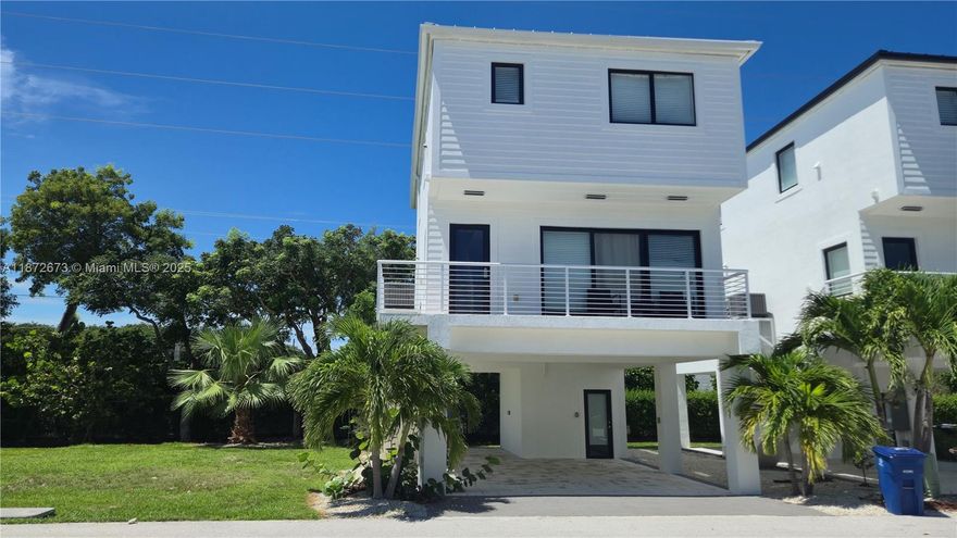 Key Largo Ocean Resort, a vibrant coastal of luxury homes. This one of a kind spacious 4-bedroom, 3.5-bathroom residence is ideal for large families or anyone seeking a slice of paradise. Thoughtfully designed with comfort and functionality in mind, the home features a generous layout, a dedicated laundry room, and a peek-a-boo view of the ocean. Downstairs, there's ample covered space for your boat and golf cart. Enjoy the ease of short-term rental setup or settle in for year-round serenity. KLOR is a gated, amenity-rich community offering: A full-service marina (currently all slips are occupied; a waiting list is available) A private concrete boat ramp with direct ocean access, swimming pool, fitness center, tennis and basketball courts, clubhouse and more.