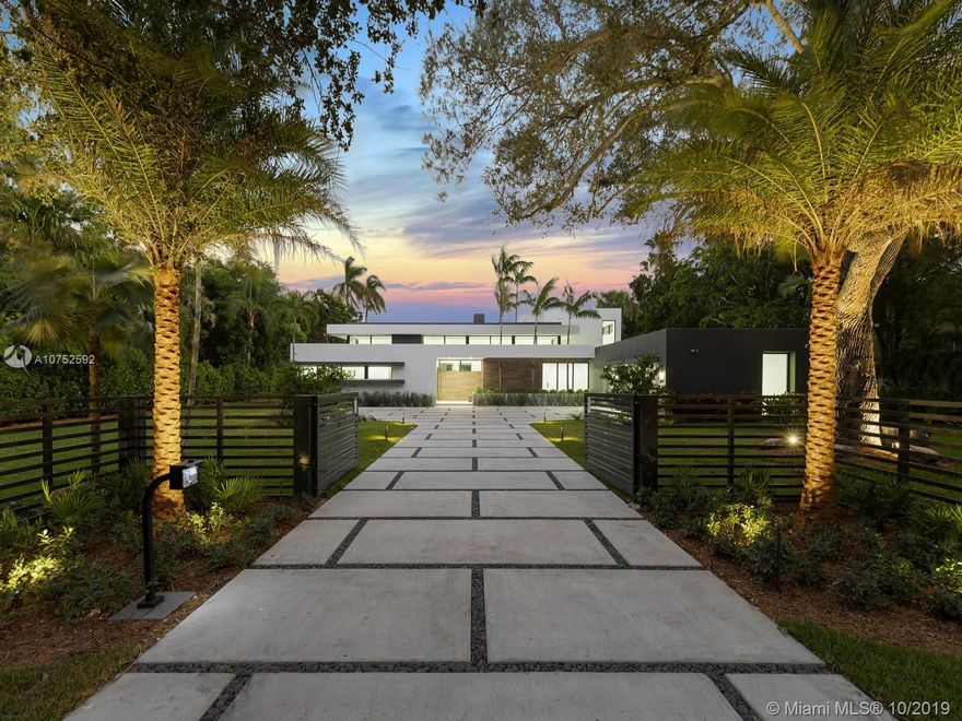 Brand new modern estate located in Pinecrest. Greeted by a pivoting door leads to a gorgeous home offering a boundless flr plan w/exquisite finishes. The grand living & dining rm offer double height ceilings & endless outdr views by its oversized flr to ceiling high impact windows & drs. Master suite on the ground level w/sitting area, walk-in closet, a gorgeous mastrbth w/double shower, floating tub & double vanities. Floating staircase leads to 3 upstairs bdrms, all opening to an expansive balcony. Amenities incl: Concrete Roof, designer kit w/Miele appl, incl gas range & wine cooler. Porcelain & wd flrs throughout, Smart Integration, Resort Style Pool w/Multicolor Jets, Summer Kit, 3 car garage, Gated, natural gas, generator ready. VISIT OUR PROPERTY VIDEO: https://youtu.be/f_J2CJmaprQ