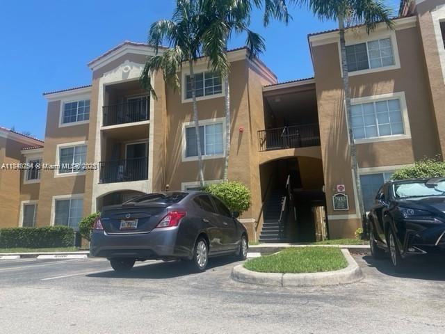 SALE BY OWNER! Located in a gated community in Tamarac, this beautiful apartment offers serene garden views and is situated in a 3-story building. Tenant occupied. It features 2 bedrooms and 2 bathrooms, along with a spacious balcony perfect for relaxing. The kitchen includes a central island, a pantry, white appliances, and elegant wood cabinetry. The unit is in excellent condition, showcasing modern-style wood flooring. Additional highlights include a covered patio, an in-unit laundry area, and assigned parking. The community offers excellent amenities such as a swimming pool, fitness center, tennis courts, and a scenic lake. Conveniently located near Sawgrass Mills Mall and major highways, and just across from Tamarac Sports Park, this property enjoys a prime and accessible location.