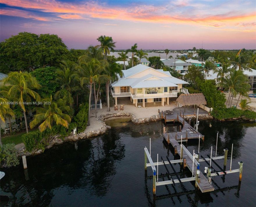 A rare jewel in the Florida Keys, this extraordinary open-water estate captures sunsets like works of art. Positioned on the peak of desirable Stillwright Point with 100 ft of waterfront, this expansive CBS home offers 4 bedrooms, 3.5 baths, and sweeping bay views from the Primary and Secondary Bedrooms. A chef’s kitchen and wide-open living space are framed by a wall of windows creating a majestic Bay View. Outdoors, a huge tiki, private sandy beach, deep-water dock with two boat lifts, 24K pounds and 15K pounds, and a jet ski lift deliver a true resort lifestyle. With 4-car covered parking, electric gates, workshop, impact windows and accordion shutters, icemaker, and quick proximity to Miami and Fort Lauderdale, this estate defines world-class Florida Keys living.