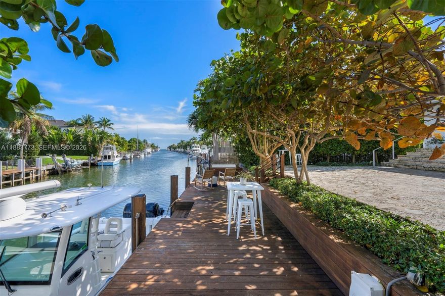 A beautifully appointed waterfront home in the gated community of Gables by the Sea, this 4-bed, 4.5-bath plus den residence spans 4,467 sq ft on a 12,366 sq ft lot with direct ocean access, 50 ft seawall, and private dock. Interiors showcase a chef’s kitchen, custom wet bar, wine cellar, and spacious living areas designed for entertaining. The expansive primary suite offers walk-in his and hers closets and a private terrace. Enjoy alfresco living on the covered patio with saltwater pool. With 3 upstairs bedrooms featuring ensuite baths, 1 downstairs, and a den, this home blends coastal elegance with modern luxury in one of South Florida’s most desirable neighborhoods.
