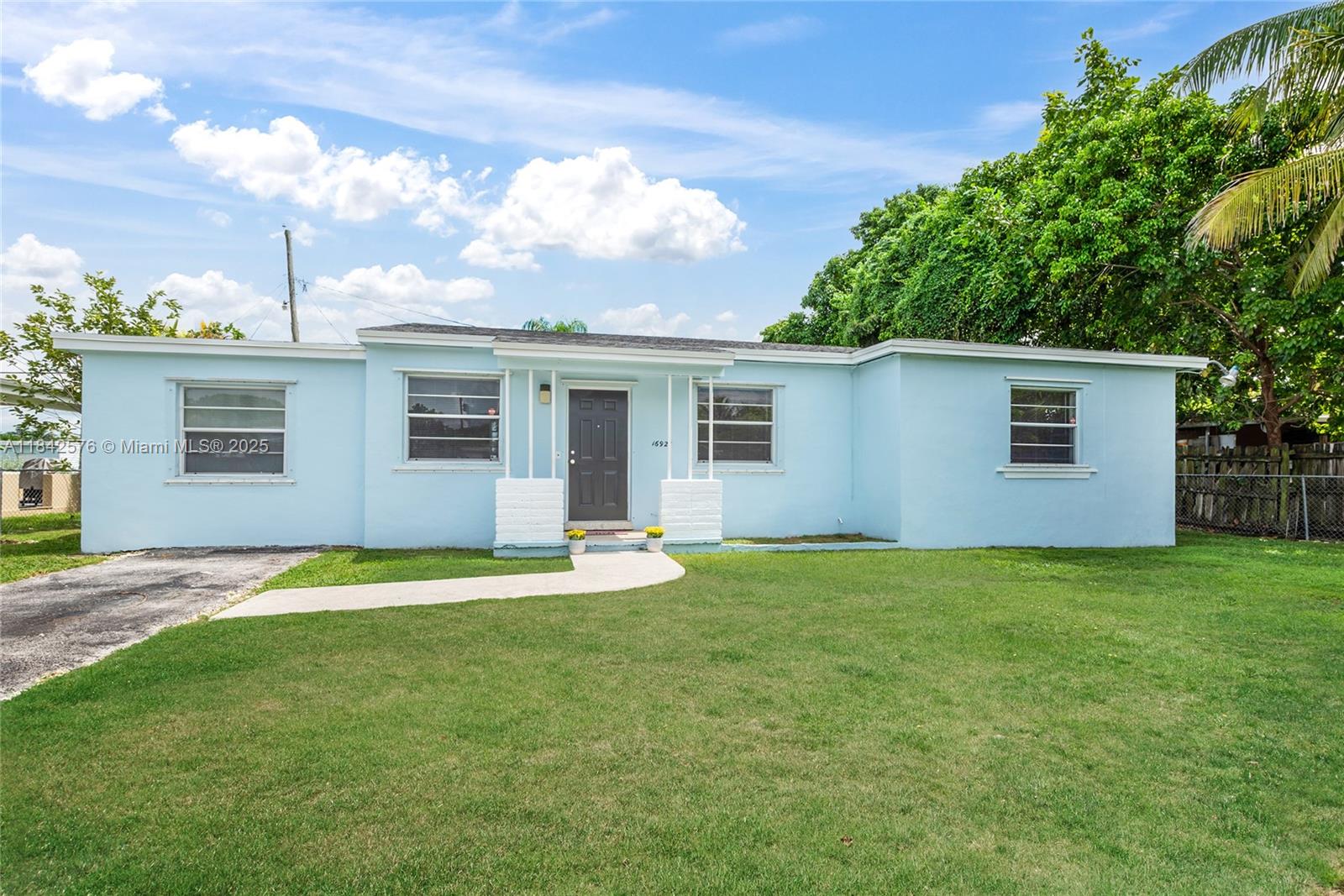 Welcome to your future home! This warm and inviting single-family residence has 3 spacious bedrooms and 2 bathrooms offering over 1,338 sq ft of comfortable living space. Step inside to discover an updated interior that beautifully blends modern upgrades with classic charm. Freshly painted, new flooring and updated kitchen with new cabinets and quartz countertops. Enjoy peace of mind with a brand-new roof under warranty, new water heater, new hot and cold-water lines and it has also been professionally treated for termites. The home is situated on a spacious 7,875 sq ft fenced lot with mature lychee trees. Unique to this property is an enclosed AC carport providing a versatile space. Currently used as a storage space/laundry room, it can easily be converted into an additional living space.