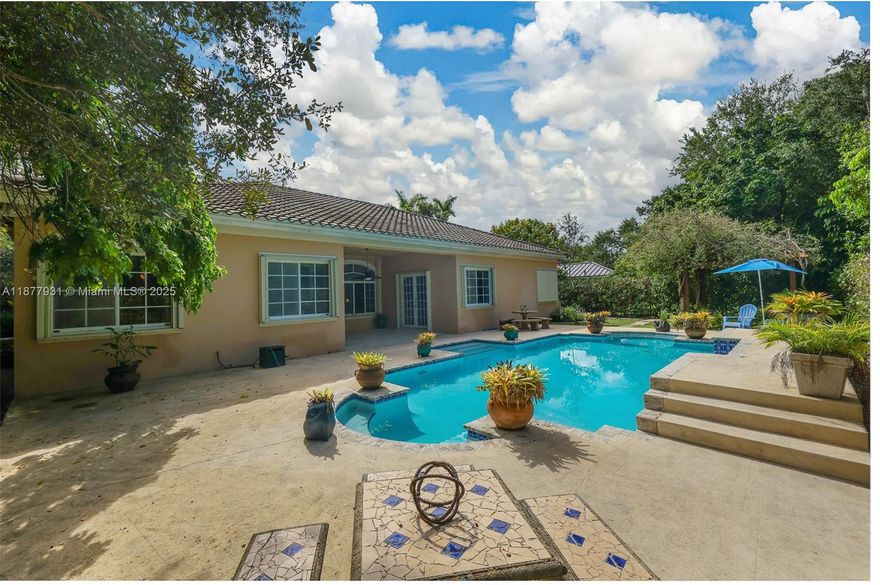 Experience the stunning Mediterranean home situated in the highly desirable Palmetto Bay. This community stands out for its beautiful green spaces, top-tier schools, and a secure, peaceful environment that families seek. This exceptional property, located on a cul-de-sac, features 5 bedrooms & 3.5 baths, along with an elegant formal dining room and a living room that effortlessly connects to a large family area. With impressive vaulted ceilings & tile flooring throughout, this home exudes sophistication, enhanced by attractive plantation shutters and broad open spaces. Lush landscaping includes a sparkling pool, all set on an extraordinary 14,521 sq ft lot. **With a full-price offer, the seller is willing to provide a concession towards the buyer's mortgage rate buydown.**