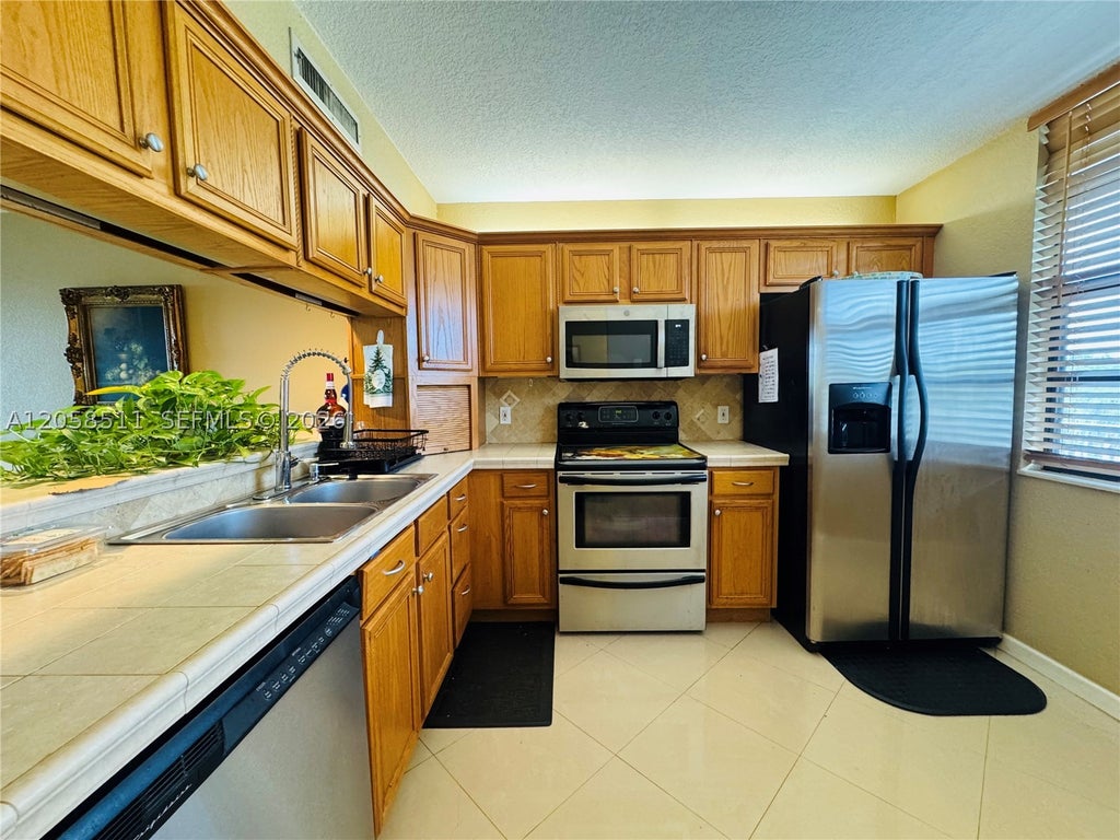 Photo of 1705 Whitehall Dr #401, Davie, FL 33324 (MLS # A12058511)