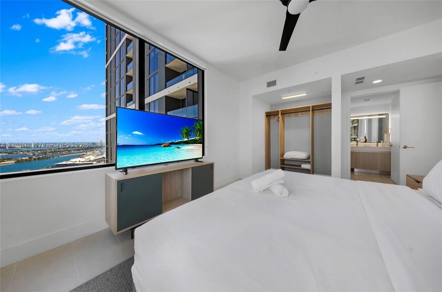 Perched on the 42nd floor, this corner residence captures sweeping views of Biscayne Bay, the Miami skyline, and Miami Worldcenter. Enjoy sunrise views from the king suite, two private balconies, and a spacious living area with a sofa bed. A fully equipped kitchen, in-unit laundry, and three Smart TVs add comfort. At Gale Miami, indulge in 55,000 sq. ft. of resort amenities—rooftop pool and bar, spa with hammam, sauna, and fitness center. With flexible daily rentals and a prime location steps from Kaseya Center, Brickell, and Brightline, this residence blends lifestyle and investment.