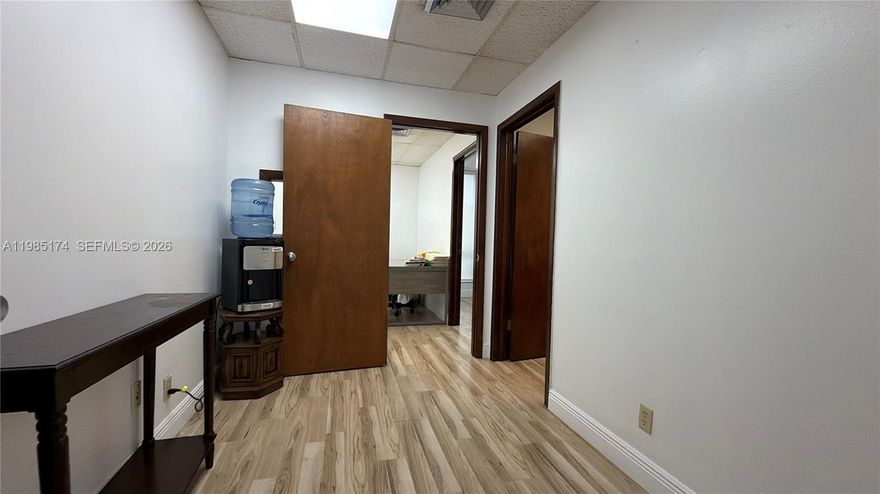 Affordable office space available on Hollywood Blvd for under $2,000/month, with electricity and water included. This approximately 800 SF unit features a functional layout with multiple private offices, making it ideal for professional use such as legal, accounting, real estate, or general office operations. The space offers modern wood-style flooring, updated lighting, and a clean, professional environment throughout. Convenient central location just east of I-95 with easy access and on-site parking. Move-in ready and easy to show.