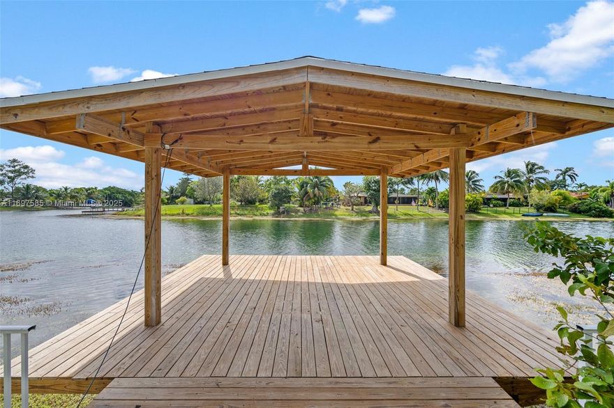 Looking to live in paradise?  You have just found your DREAM HOME!  Tropical lake and pool. Exquisite and elegant dock where you can view morning sunrises and afternoon sunsets.  A Concrete retaining wall and a separate protective fence for children and animals across the shoreline. Southern breezes flow into your home.  2 master bedrooms.  Split bedroom plan.  Ideal for entertaining inside and outside.  New hurricane impact windows and doors throughout.  Brand new roof.  Perfect to park a boat.  Two car garage.  Ideal neighborhood for families. Amazing park, Elementary and Golf Course nearby. When only the best will do!  Call or text agent for all showings. Requires 24 hour notice.