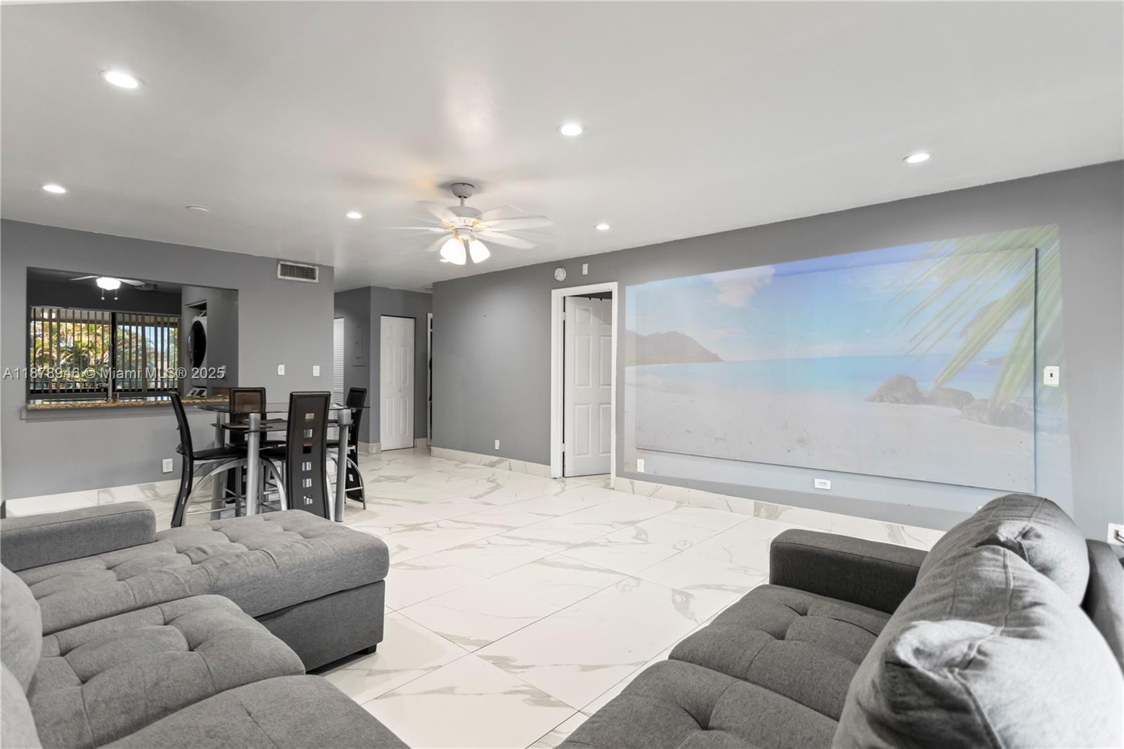 Step into comfort and entertainment with this charming condo featuring built-in projectors in both the living room and master bedroom for the ultimate home theater experience, perfect for the whole family. The updated kitchen adds a modern touch and very spacious bedroom and closet space. Located in a quiet, safe community surrounded by lush nature, residents enjoy fantastic amenities: sparkling pool, sports courts, gym, clubhouse with billiards, and a BBQ area under the trees. All this while being conveniently located across from a shopping plaza with Walmart, Ross, Marshalls, restaurant and just minutes to the Turnpike, 441 and the beach. A perfect balance of lifestyle, entertainment, and location! Right at the intersection of three Cities, Margate, Coconut Creek and Pompano Beach. 5% DP