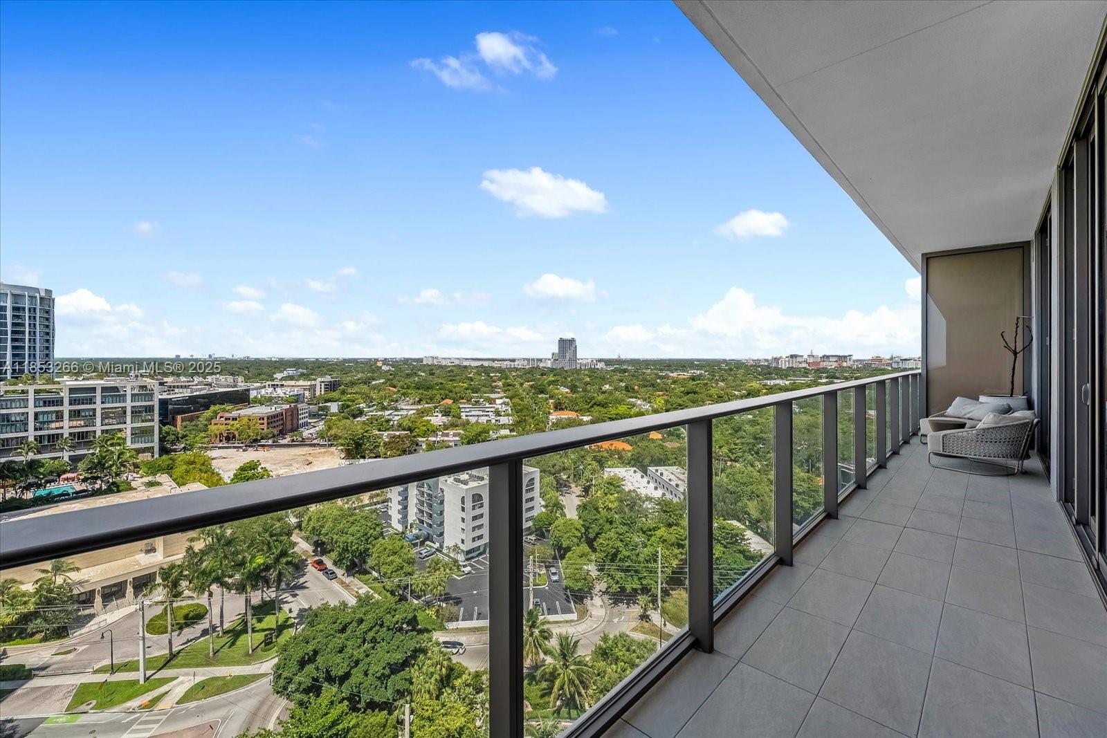 The open-concept layout features floor-to-ceiling windows, filling the space with natural light and framing serene views of Biscayne Bay, Coconut Grove’s lush canopy, or the Miami skyline. The sleek chef’s kitchen is outfitted with custom Italian cabinetry, premium Sub-Zero and Wolf appliances, and quartz or terrazzo countertops – perfect for both everyday living and entertaining.