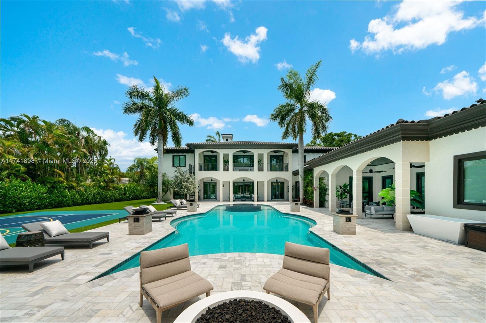 Located in a sought-after Pinecrest neighborhood with top-rated schools, this gated 7-bedroom, 8.5-bath estate is move-in ready and filled with standout amenities. The backyard features a saltwater pool, spa, cold plunge, sauna, gym, pickleball/basketball court, and a fully equipped summer kitchen, ideal for entertaining and everyday enjoyment. Inside, the open layout includes a chef’s kitchen with a striking L-shaped marble island, a formal dining room, and a living area with a fireplace. The ground-floor primary suite offers a private sitting room entry, dual walk-in closets, and a spa-inspired bath. Additional features include smart home technology, a three-car garage, and renovations throughout. Experience the privacy, space, and lifestyle this Pinecrest estate offers like no other.
