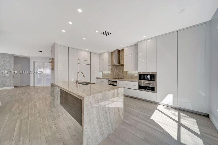 Stunningly Renovated 4- Bedroom, 2.5 Bath Pool Home in Silver Shores. This elegant 2- story home is located on a premium lot backing to a private nature preserve in the beautiful guard gated community of Silver Shores. This bright and spacious home features an open floor plan with high ceilings, recessed lighting, and elegant Spanish porcelain tile flooring throughout the main level. The designer gourmet kitchen showcases Taj Mahal Quartzite countertops, a waterfall island, Italian cabinetry, and high-end built-in appliances, including Sub-Zero/Wolf refrigerator, oven, coffee maker, Fisher & Paykel induction cooktop, Zephyr range hood, and GE Monogram wine cooler. The kitchen overlooks the outdoor patio and solar-heated saltwater pool, creating the perfect indoor-outdoor entertaining space. Upstairs features water-resistant vinyl flooring and a spacious primary suite with vaulted ceilings and dual walk-in closets. Additional features include glass stair railings, Aquabrass fixtures, Madeli vanities, impact front and sliding doors, accordion shutters, laundry room with cabinetry, and a 2-car garage. Prime location near I-75, shopping, dining, and more.