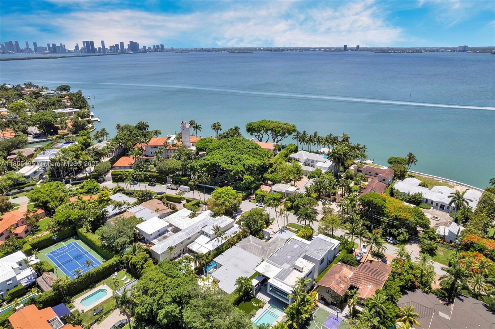 On a 12,000 sq ft lot in prestigious North Bay Road, this elegant through a hidden garden leads to an open-concept interior perfect for entertaining. The gourmet kitchen features premium appliances and custom cabinetry. The laundry room includes a utility sink and storage. The private primary suite has his-and-hers walk-in closets. There are three additional bedrooms, each with an en-suite bathroom, plus a guest room or office. The family room opens to a den with a built-in bar, which flows out to a lounge and heated pool. The home includes a double garage, a 3-year-old Generac gas generator, a whole-house water filtration system, and a security system. This property combines comfort and elegance, moments from Miami Beach.