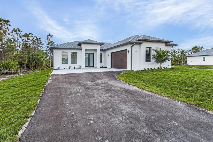 Looking for Privacy and a TONS of Space? This is the one for you. 2.27 acres of flat and mostly cleared land. ALL UPLANDS. Ready for any projects or additions! This stunning, 3 bedroom plus den, new construction is situated in the beautiful Golden Gate Estates, in Naples FL. The great attention to details and high quality built is evident throughout the house; featuring tall french doors, a lovely and airy living room with tile throughout the house, a modern light gray Custom Wood Cabinetry kitchen with quartz countertop, a waterfall island, tasteful backsplash, soaring high tray ceilings, beautiful crown molding on main living area and master bedroom, 6" baseboards throughout, 8-ft doors, and a beautiful touch of modern with waterfall faucets in the bathrooms. This property also features asphalted driveway, automated sprinklers and ALL IMPACT RESISTANT WINDOWS AND DOORS. MLS pictures are a representation of house of same model with similar finishes, not actual property. There will be some variations.