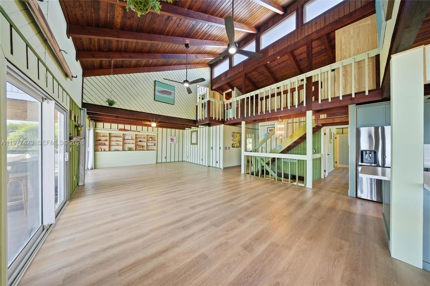 This striking 4-bedroom, 3-bathroom home is a testament to coastal architecture, blending rustic design with open, light-filled living spaces that showcase a breathtaking oceanfront setting. Situated on a double lot totaling .32 acres, the property offers an impressive 120 feet of frontage overlooking Cudjoe Bay—creating a rare and commanding presence along the shoreline.
Broad covered balconies and generous outdoor living spaces capture the essence of Keys waterfront living, while large impact glass doors and windows frame sweeping ocean views and invite natural light throughout. Soaring ceilings with dark wood beams enhance the open-concept layout and add dramatic architectural character.
The main living level features a fully renovated kitchen, dining area, expansive living room, laundry, two bedrooms, and two bathrooms. Upstairs, a third bedroom sits at the top of the stairs, while a catwalk leads to the fourth bedroom with an ensuite bath and walkout deck positioned to capture the home’s most spectacular panoramic views.
Throughout the residence, thoughtful design blends contrasts—modern lines with traditional warmth, cozy intimacy within spacious rooms. Whimsical and eclectic touches pair with bold architectural elements, creating a home that feels both artistic and inviting while celebrating its extraordinary oceanfront setting.