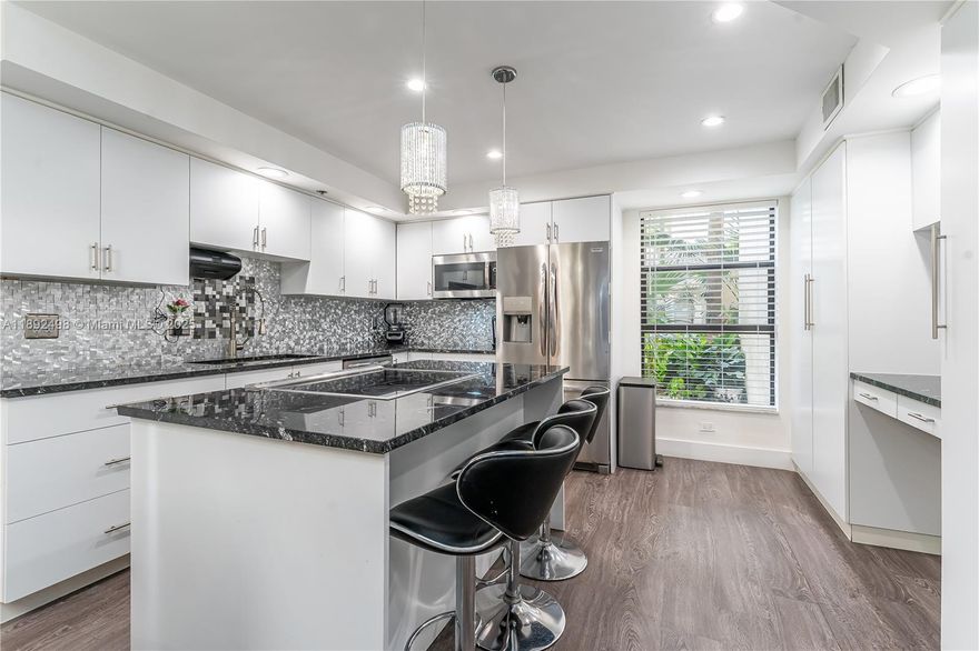 Stunning oversized corner-unit, two bedroom two & a half bath condo completely updated in a 55+ gated community!! One of the largest units in the complex on the first floor overlooking the pool!  Oversized kitchen with island & tons of cabinets.  Impressive foyer entrance leading into the large dining & living area.  Elegant lighting throughout, including recessed lighting in the living room! Primary bedroom has two walk-in closets, & the bathroom has double sinks, large shower & a roman tub. Full size washer/dryer in the unit as well.  Large wrap-around screened porch, with a private patio overlooking the pool & grounds!  Fantastic community, gated, with tons of activities.  HOA includes internet, cable, water, sewer, gym, pest control, heated pool, tennis & more! This unit will not last!