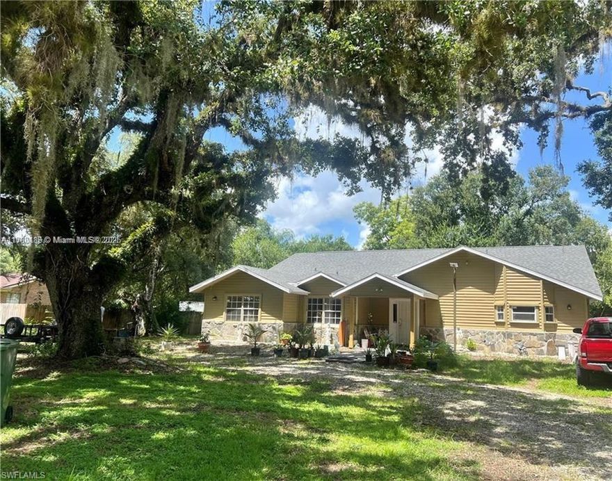 Nestled on an oversized 0.62-acre lot (27,007 sq. ft.) surrounded by majestic LaBelle oaks, mango, and avocado trees. Built in 1990, this 3-bedroom, 2-bath home boasts high ceilings, recessed lighting, and an open-concept layout, perfect for comfortable living and entertaining. Enjoy the Florida lifestyle on the expansive 692 sq. ft. screened-in porch, ideal for relaxing or hosting gatherings. Recent updates include a new roof (2022), ensuring peace of mind for years to come. The detached 2-car garage provides ample storage space and can double as a workshop for your hobbies or projects. Conveniently located near schools, shopping, and dining, this home offers a perfect balance of privacy and accessibility. Don’t miss the opportunity to make this beautiful LaBelle retreat yours!
