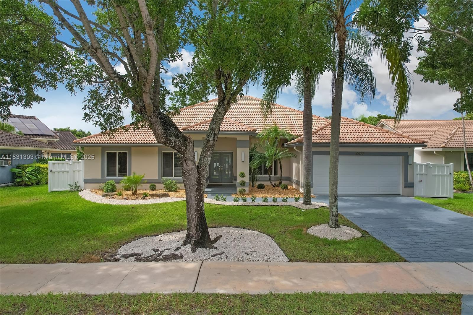 Stunning home with $170K+ in upgrades in sought-after North Springs!,This beautiful 4/3 home,plus den,features a spacious 9,401 sqft lot.As you walk through the dbl door entryway you are greeted by a huge open plan layout & vaulted ceilings & High tech sec camera system.Oak wood look porcelain tile floors in living areas,Beautiful Custom kitchen w/ huge island,Porcelain waterfall counters & Thermador integrated appliances.Split floor plan w/ Spacious bedrooms & large owner suite w/ dual walk-in closets & spa like en-suite bathroom.Captivating views to a private backyard oasis w/ a screened in Pool & outdoor kitchen,mature fruit trees,New Impact windows & doors,newly painted & landscaped w/ a stamped concrete driveway,large 2 car garage w/ new epoxy floors,new garage door & system. No HOA.