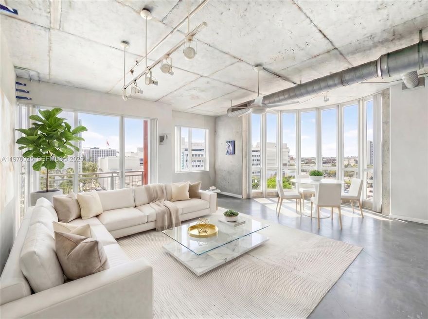 Modern NYC loft-style condo in the sought-after Cite on the Bay, located in the heart of Edgewater. This rare top-floor corner unit offers 2 bedrooms, 2 bathrooms, and 1,351 sq ft of soaring open-concept living space — all beneath dramatic 12-ft ceilings with floor-to-ceiling impact windows that frame unobstructed sunset views over Biscayne Bay. The expansive living and dining area opens effortlessly to a private balcony, ideal for entertaining against a backdrop of sweeping panoramic water views. A brand-new AC and water heater mean this home is completely move-in ready. Short-term rental eligible with a 30-day minimum, making it an equally compelling choice for owner-occupants and savvy investors. Walk to Margaret Pace Park and enjoy quick access to Wynwood, the Design District, Midtown, and Downtown Miami — all just minutes away via I-95.